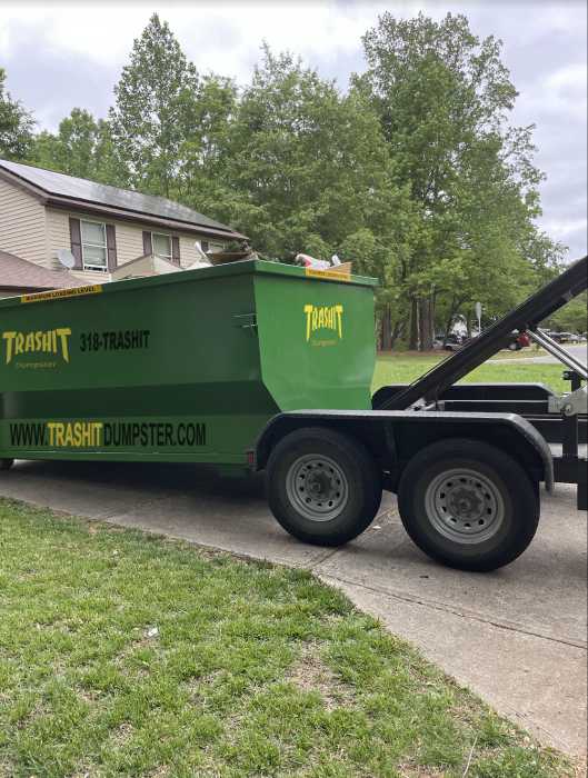 Trashit Dumpster - A green dumpster on a trailer