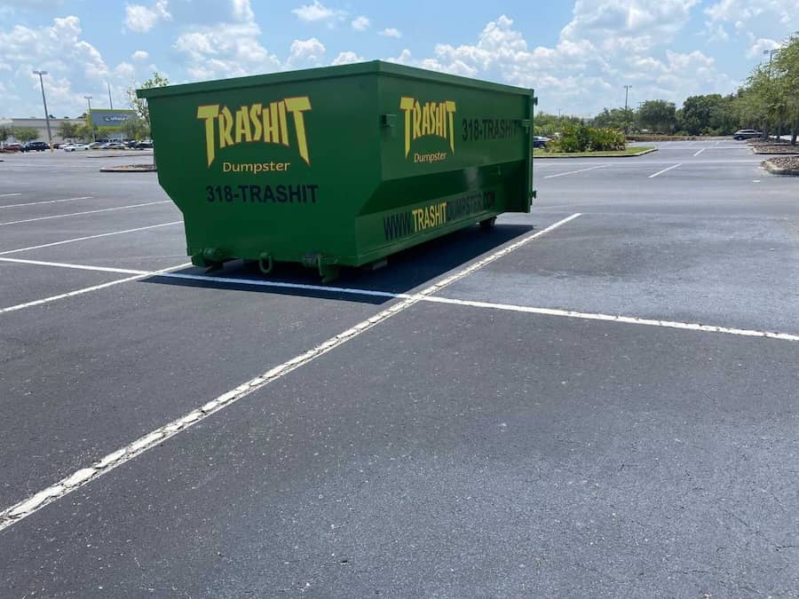 Trashit Dumpster - A green dumpster in a parking lot