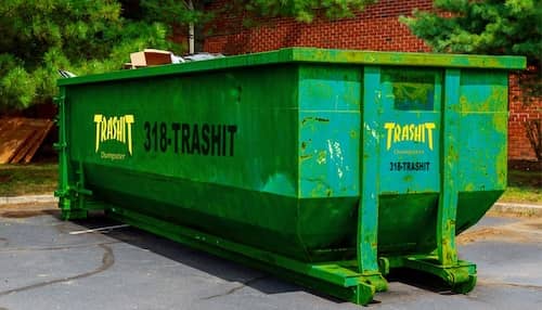 Trashit Dumpster - A green dumpster placed on the ground outdoors.